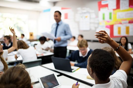 Photo of a classroom teacher instructing enthusiastic students